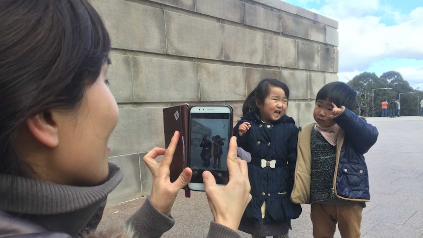 Capturing a photo of children through a smart phone camera.