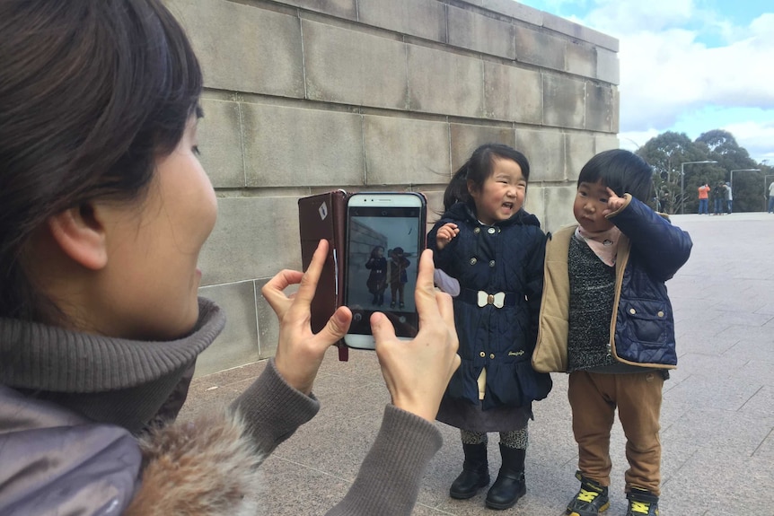 Capturing a photo of children through a smart phone camera.