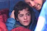 William Callaghan wrapped in blankets after being rescued at Mt Disappointment.