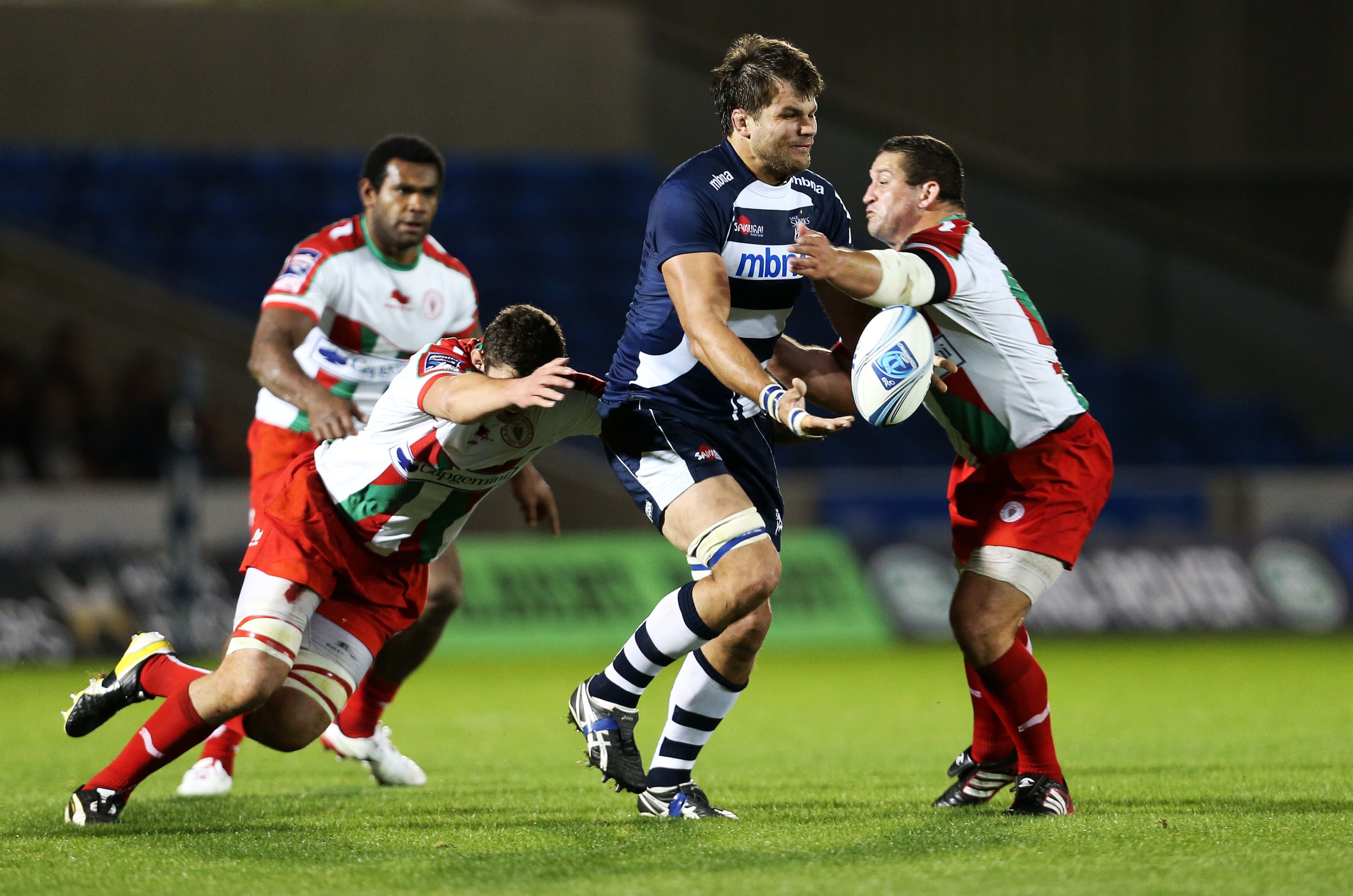 A man runs the ball during a rugby league match