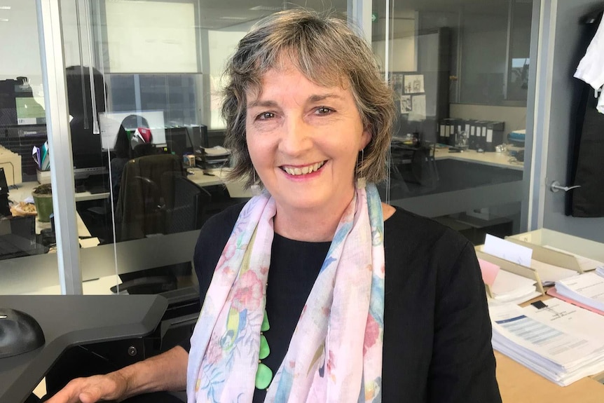 Smiling photo of Louise Johnson standing in an office.