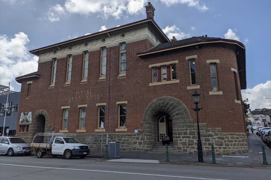 A historic-looking red brick building with featuring the title "Albany Court House".