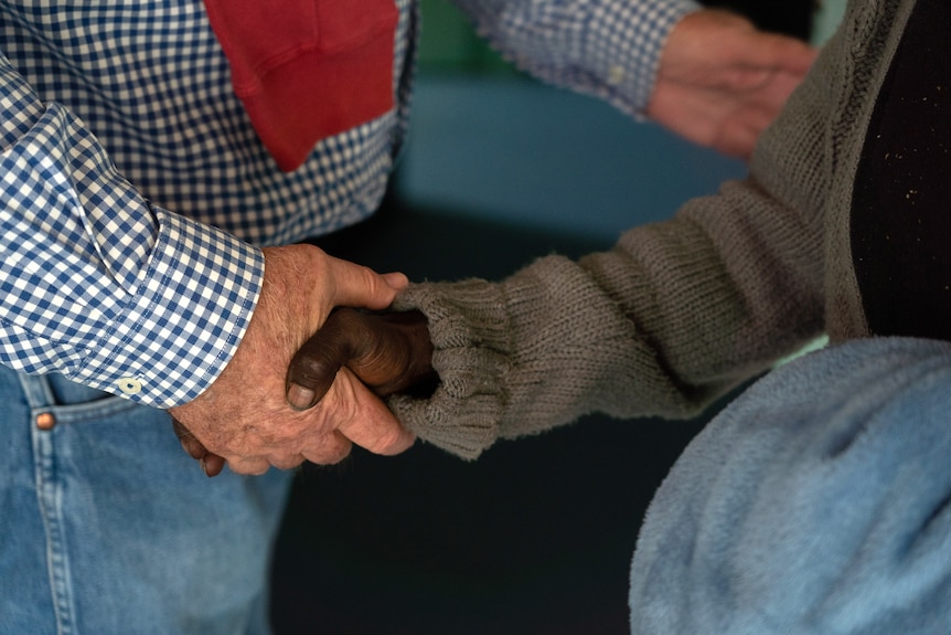 Father Mick shaking a client's hand