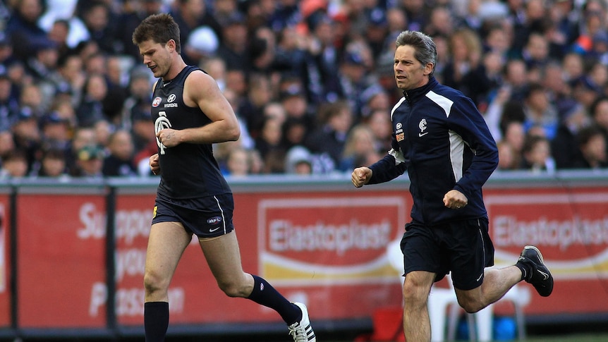 Carlton Blues Bryce Gibbs running off the field with trainer
