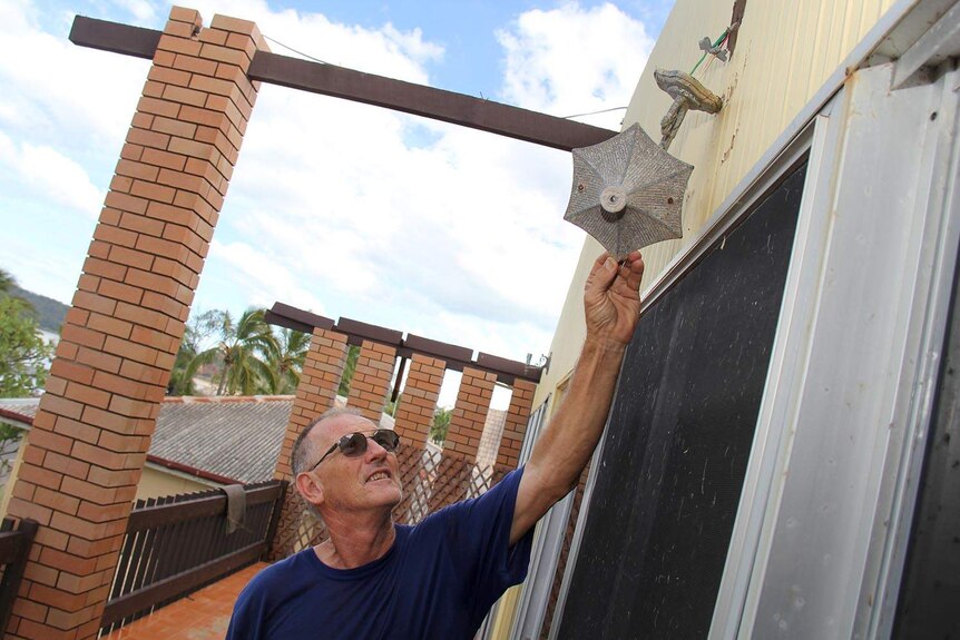 Brian Mossop on the balcony of his Yeppoon home