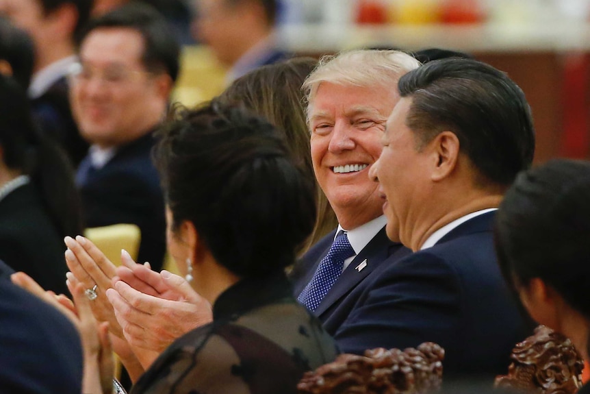 US President Donald Trump and China's President Xi Jinping attend at a state dinner.