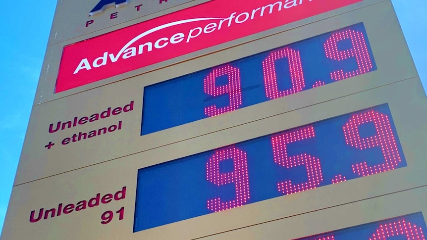 A sign shows petrol prices at 90.9 and 95.9