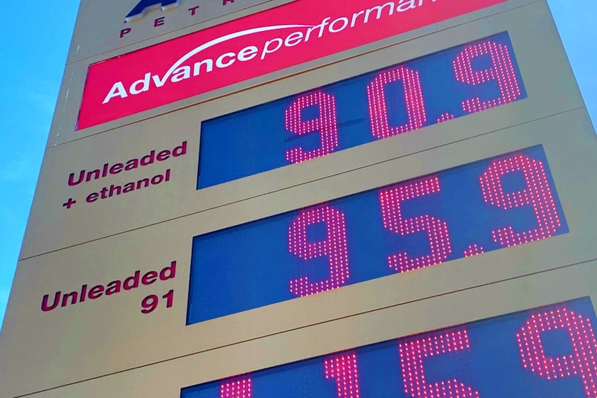 A sign shows petrol prices at 90.9 and 95.9