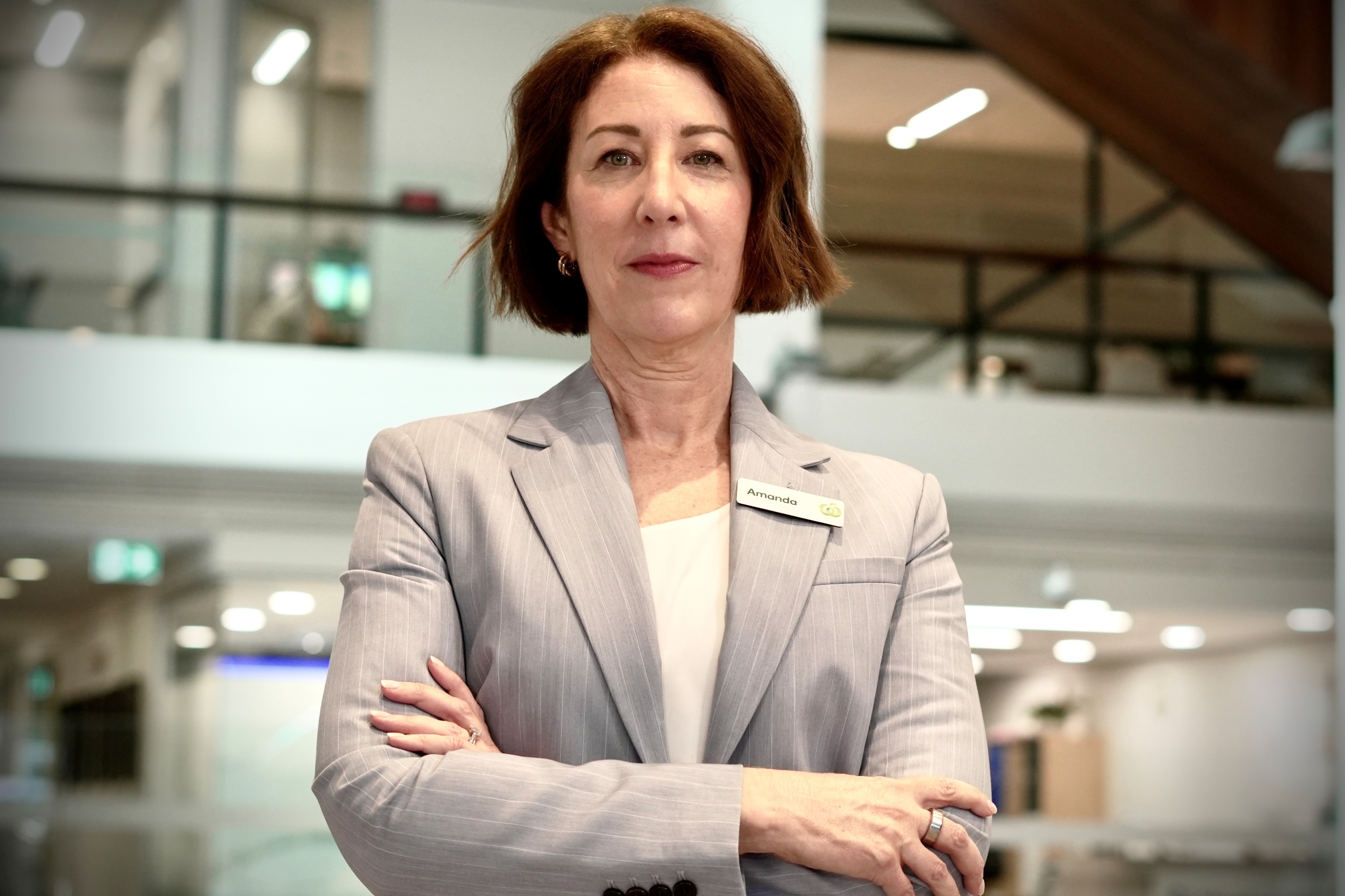 Amanda Bardwell wearing a grey suit jacket with arms cross