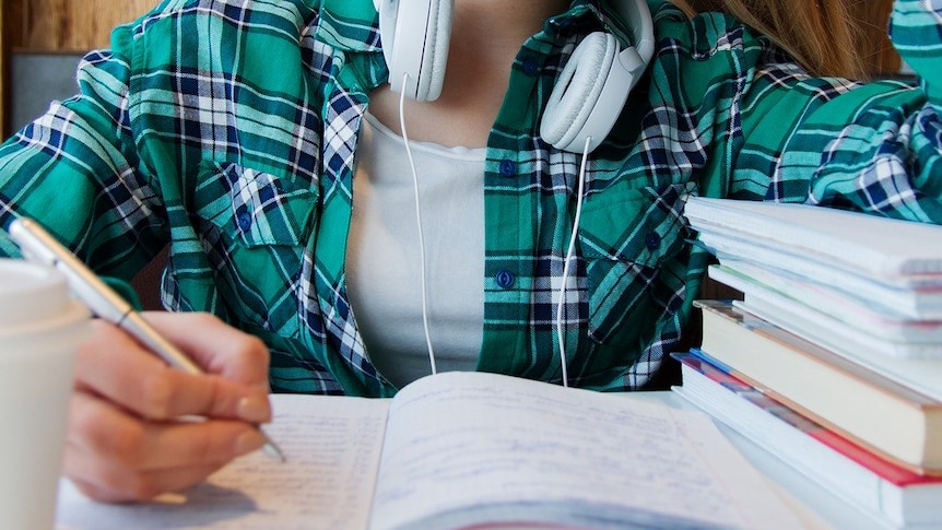 Young unidentified female student with textbooks.