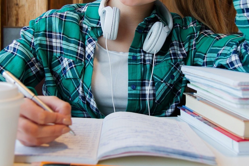 Young unidentified female student with textbooks.