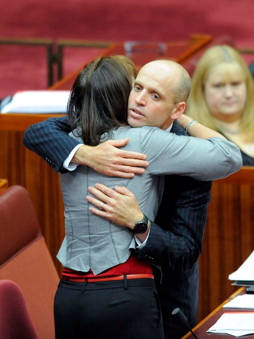 Senator Mark Arbib is farewelled by Senator Kate Lundy (L) after his valedictory speech in the Senate.