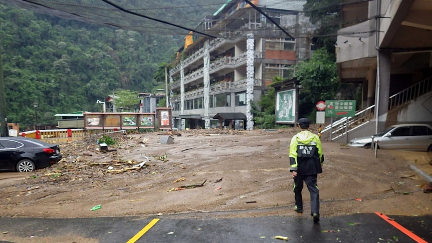 The front of a hotel is blocked by mudslide, caused by Super Typhoon Dujuan