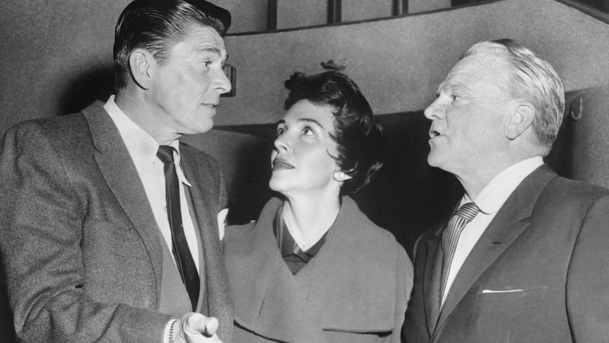 Ronald Reagan, alongside his wife Nancy, speaks with actor James Cagney at a Screen Actors Guild Rally. 