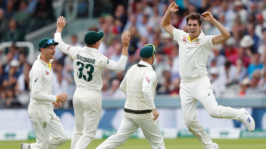 Pat Cummins jumps for joy as teammates celebrate a wicket at Lord's