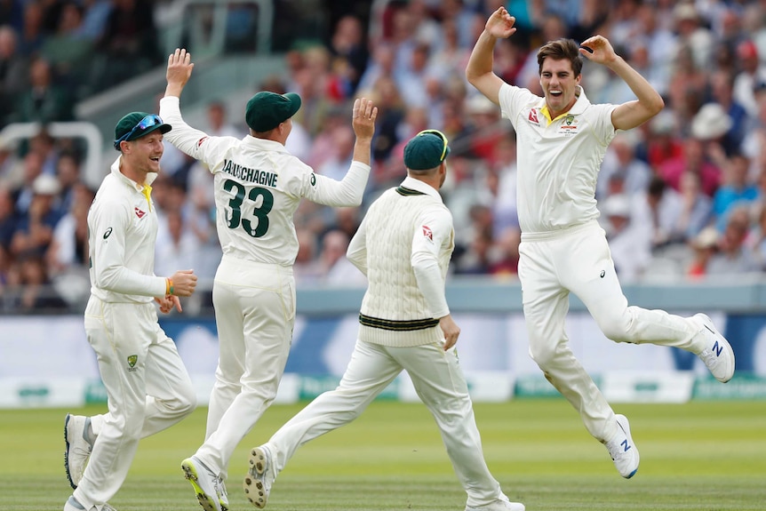 Pat Cummins jumps for joy as teammates celebrate a wicket at Lord's