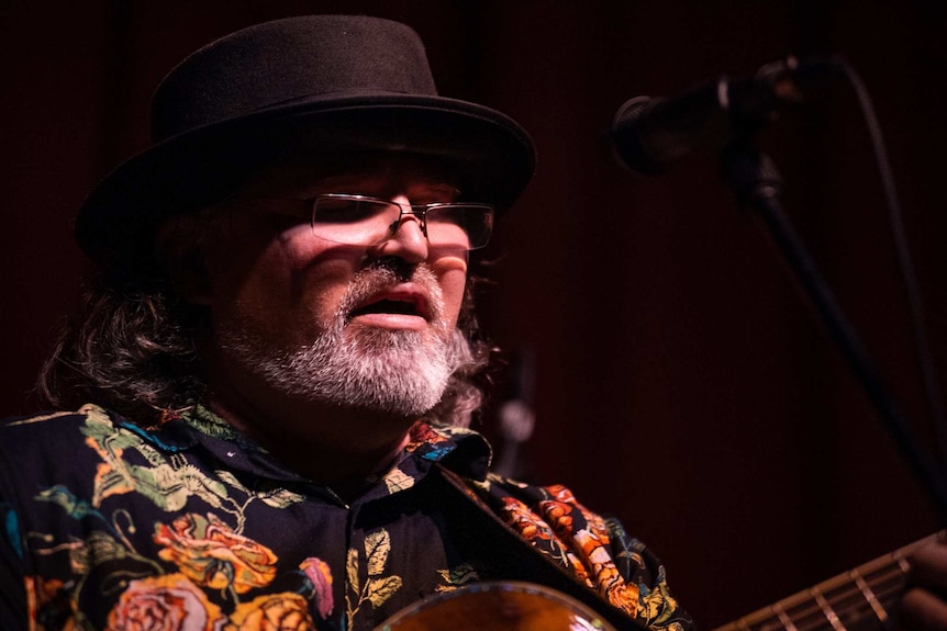 Dave Stergo sings and plays a guitar.