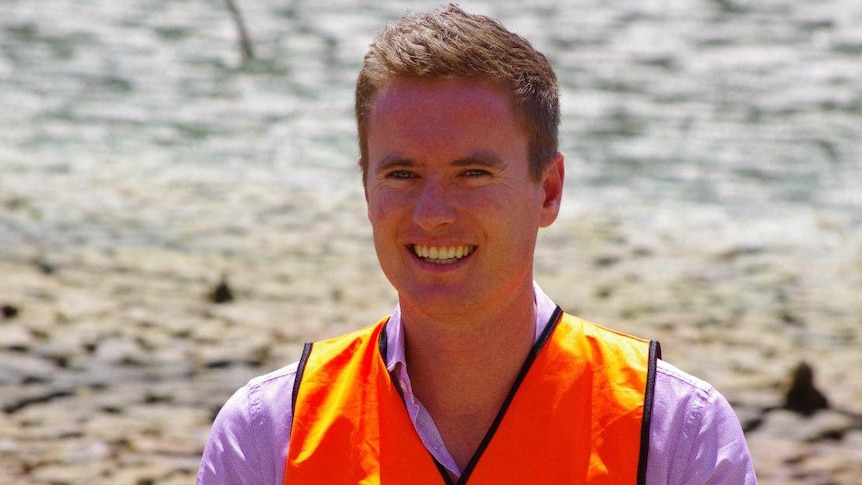 WA Environment Minister Albert Jacob in a hi-vis vest while visiting the Swan River wetlands.