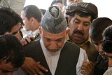 Hamid Karzai weeps at brother's funeral.