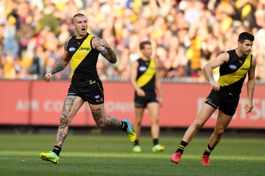 Dustin Martin pumps his fist as he celebrates a goal against the Saints.