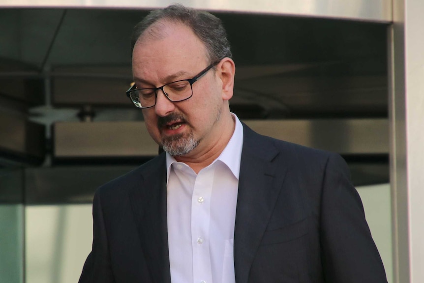 A man in a suit outside the District Court.