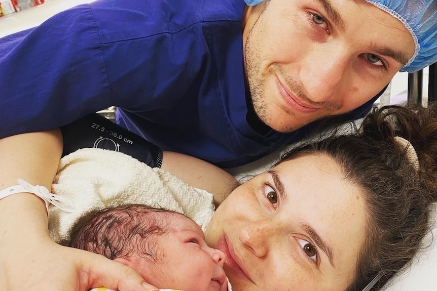 Couple with newborn baby in hospital