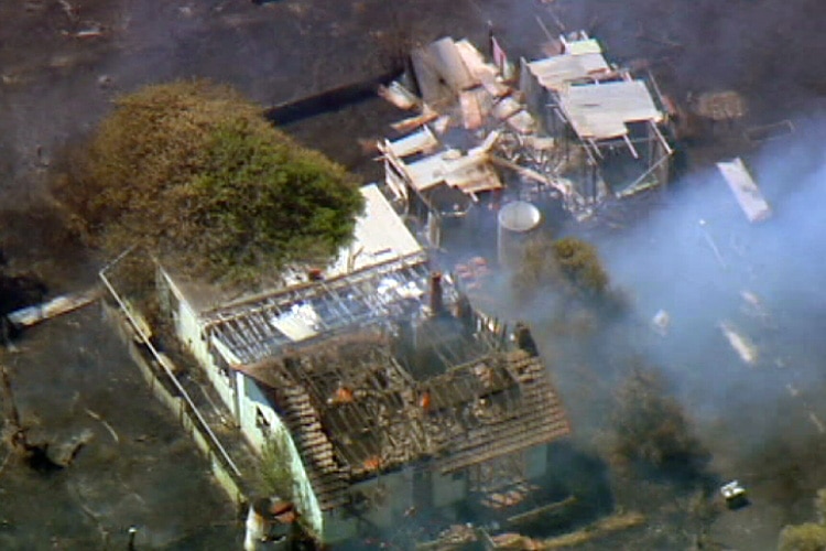 An aerial showing a damaged house the Wattle Grove fire.