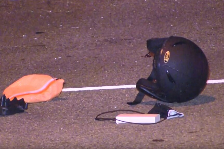 A motorcycle helmet lying on the ground.