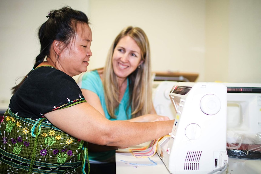 Karen refugee, Rheeta Say at the sewing machine with program coordinator, Alison Creek.