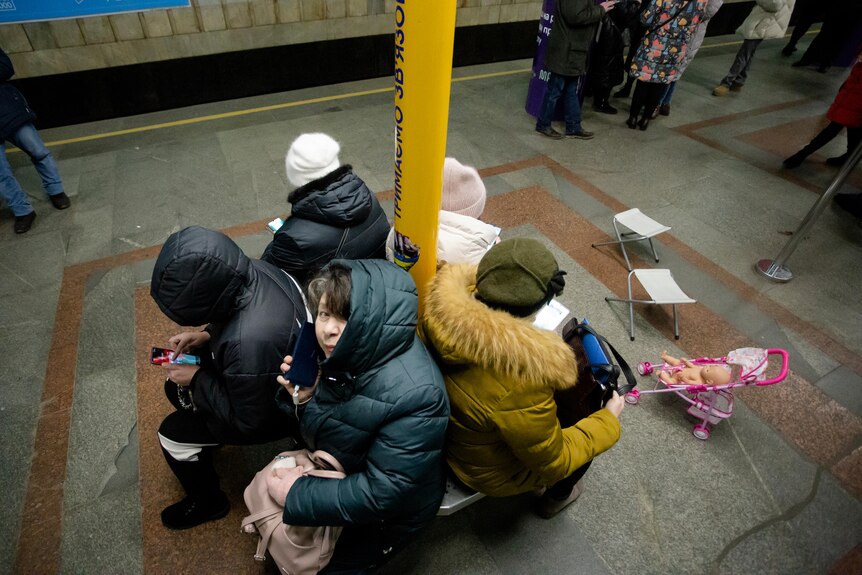 People take shelter in a subway station