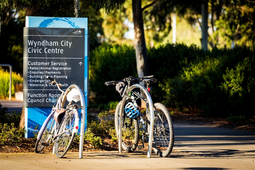 A sign saying "Wyndham City Civic Centre", with bicycles in front of it.