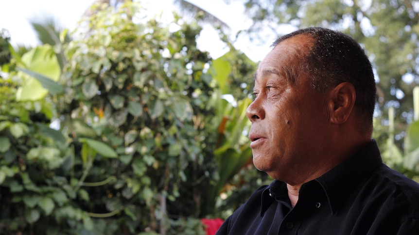 'Atatā  town officer Saotame Fonua sitting outside