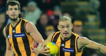 Hawthorn's James Worpel holds a football to his chest.