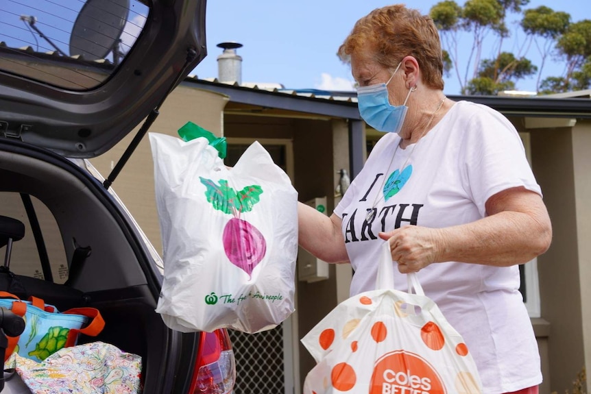 Val Williams packs shopping bags into the boot of her car.