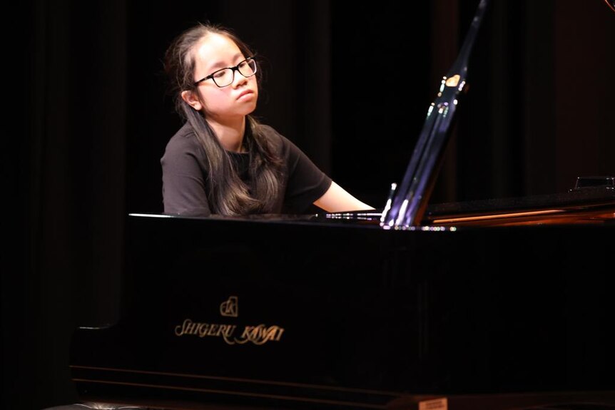 Composer and pianist Jasmine Lai plays a grand piano
