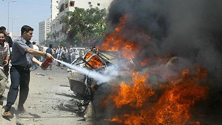 Palestinians extinguish the car of Ismail Abu Shanab