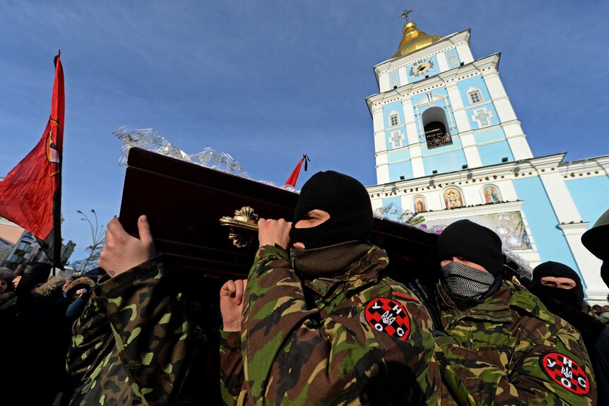 Ukrainian protesters carry the coffin of Belarussian protester Mikhail Zhiznevsky through Kiev.