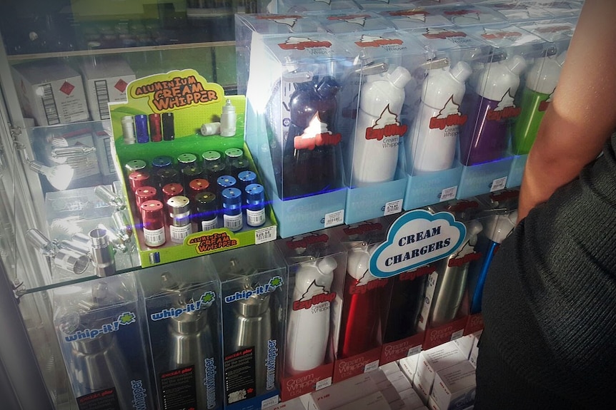 A shop shelf stocking cream chargers and accessories