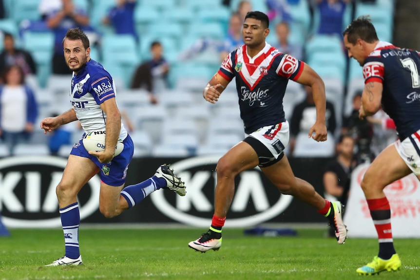 Josh Reynolds runs away from the Roosters