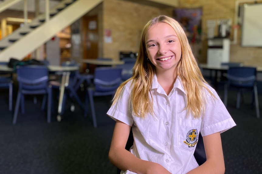 A blond girl smiling