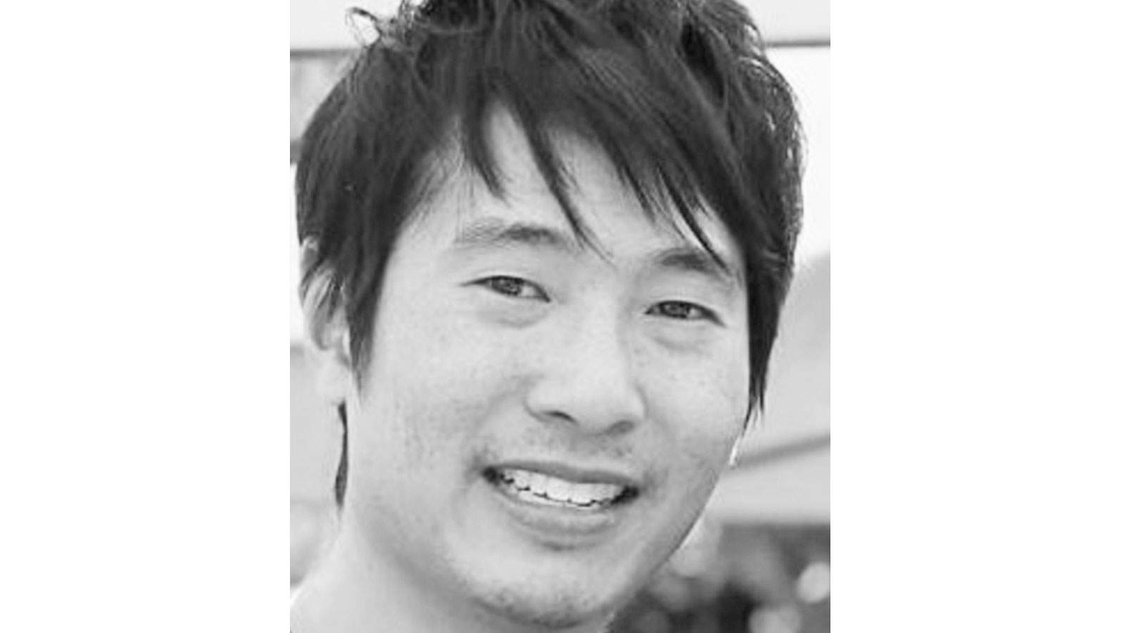 Matthew Si smiles in a close up photo.