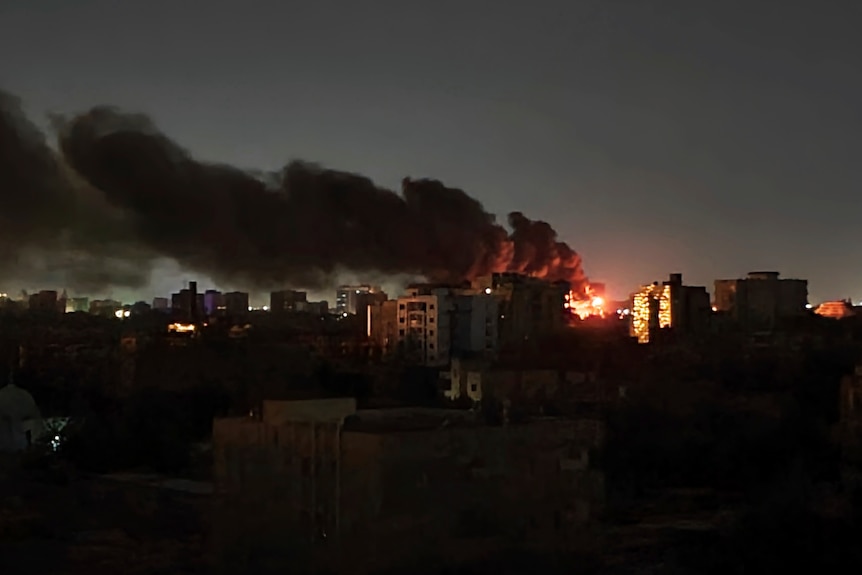 Smoke rises over the horizon as a fire burns after a strike in Khartoum, Sudan.
