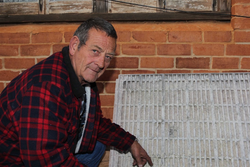 Ross Pigdon with an air-conditioning pad affected by the poor water quality.