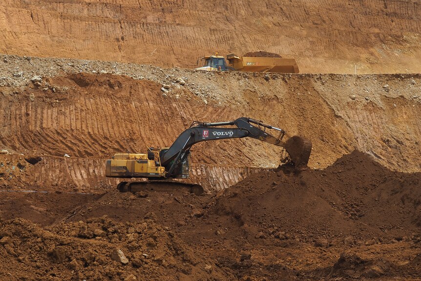 Machinery digs nickel ore from the ground.