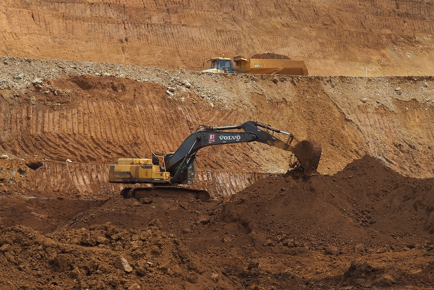 Machinery digs nickel ore from the ground.