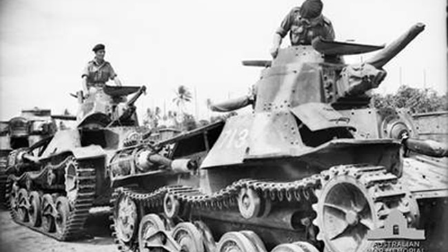 Australian crew commanders of 2/4 armoured regiment inspect captured Japanese tanks in Rabaul.