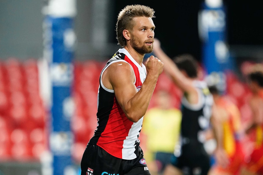 A St Kilda AFL player pumps his fist as he celebrates a goal against the Gold Coast Suns.