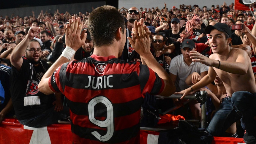The Wanderers' Tomi Juric celebrates with fans after Western Sydney's win over Adelaide.