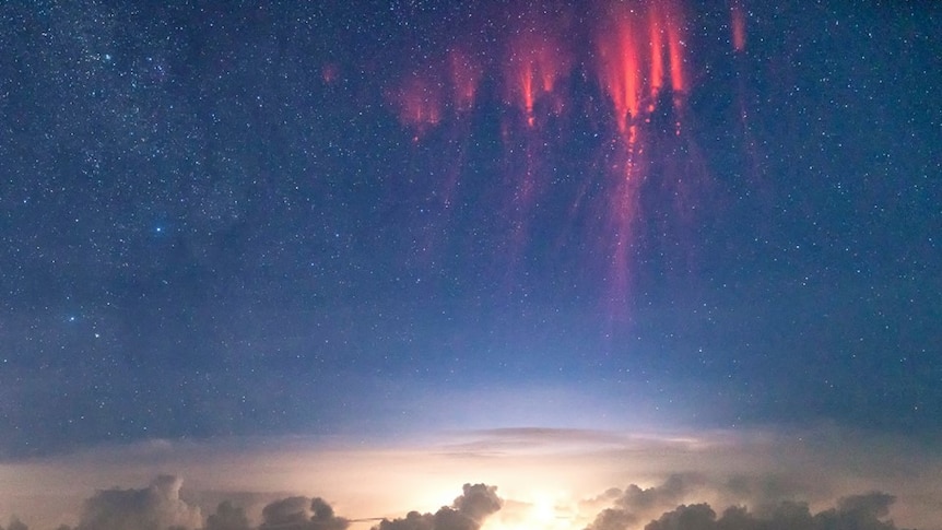 The red light of a sprite above a distant thunderstorm in the east Kimberley.