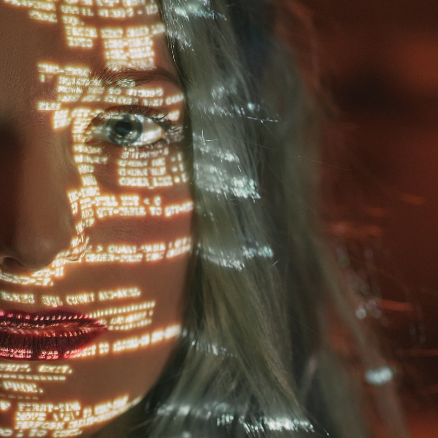 A woman's face is covered in computer data